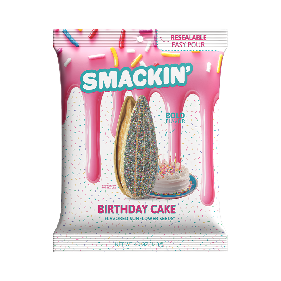 Smackin' Birthday Cake Flavored Sunflower Seeds bag featuring a pink icing drip design, scattered colorful sprinkles, an enlarged sunflower seed coated in rainbow confetti, and a small white birthday cake with lit candles