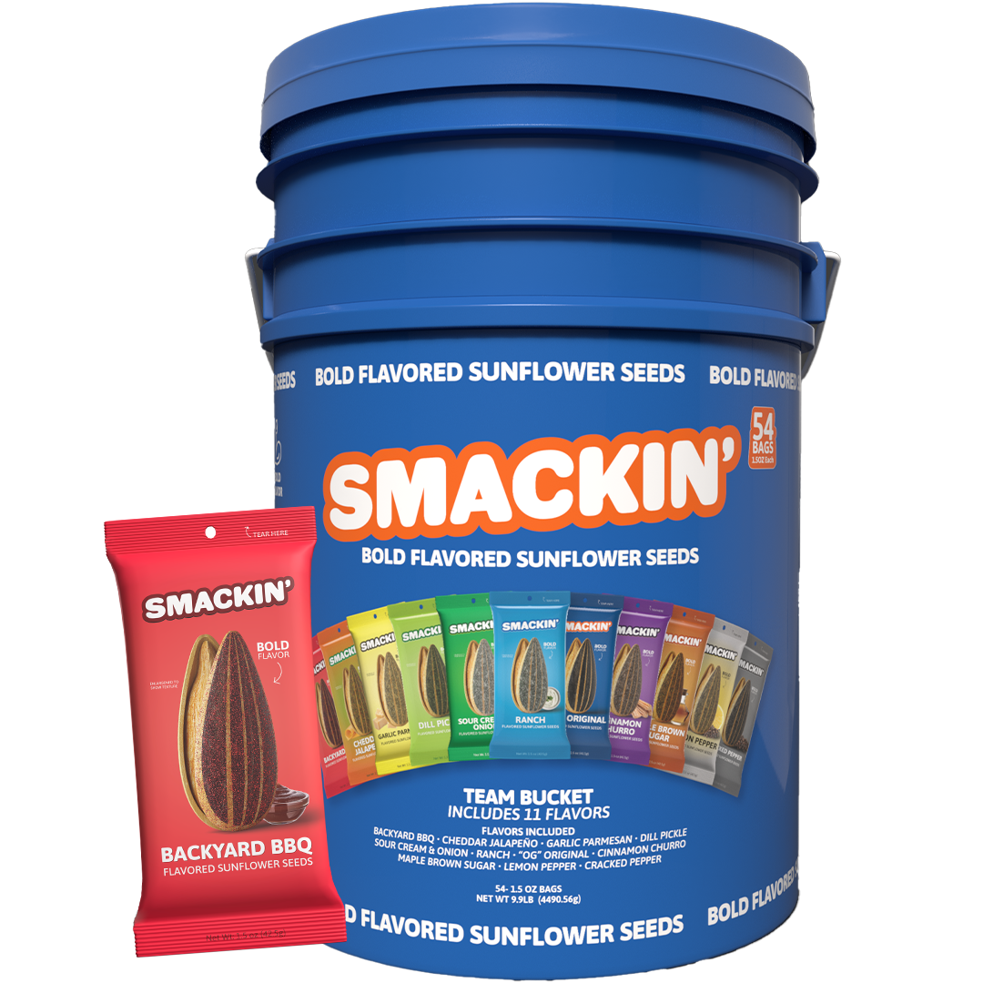 A large blue Smackin' Bold Flavored Sunflower Seeds Team Bucket containing 54 individual bags, prominently displaying a red Backyard BBQ flavored bag and a colorful lineup of 11 diverse flavors like Dill Pickle and Ranch