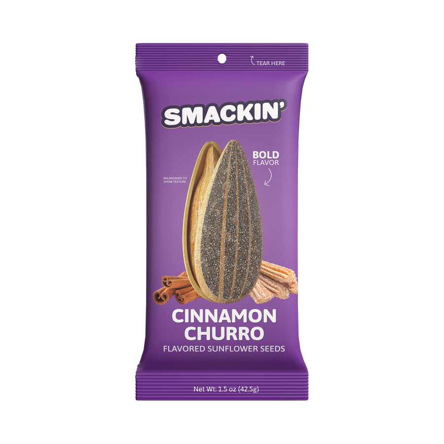 Product photograph of a vibrant purple Smackin' Cinnamon Churro flavored sunflower seeds bag displaying enlarged seeds, brown cinnamon sticks, and sugary churros against a white background with "Bold Flavor" text