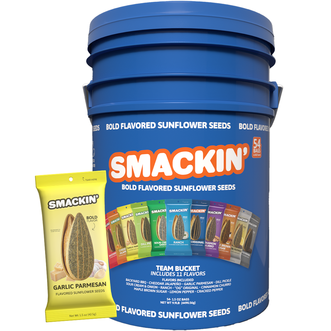 A large blue Smackin' Bold Flavored Sunflower Seeds Team Bucket showcasing 54 bags and 11 unique flavors including Garlic Parmesan, Dill Pickle, and Cinnamon Churro with a yellow Garlic Parmesan bag in front