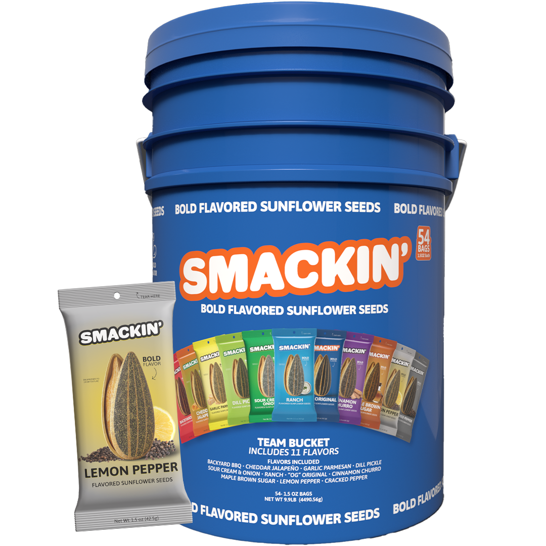 Smackin' Bold Flavored Sunflower Seeds Team Bucket a large blue container with an orange logo holding 54 bags of 11 unique flavors like Lemon Pepper Backyard BBQ and Dill Pickle displayed next to a single yellow Lemon Pepper bag