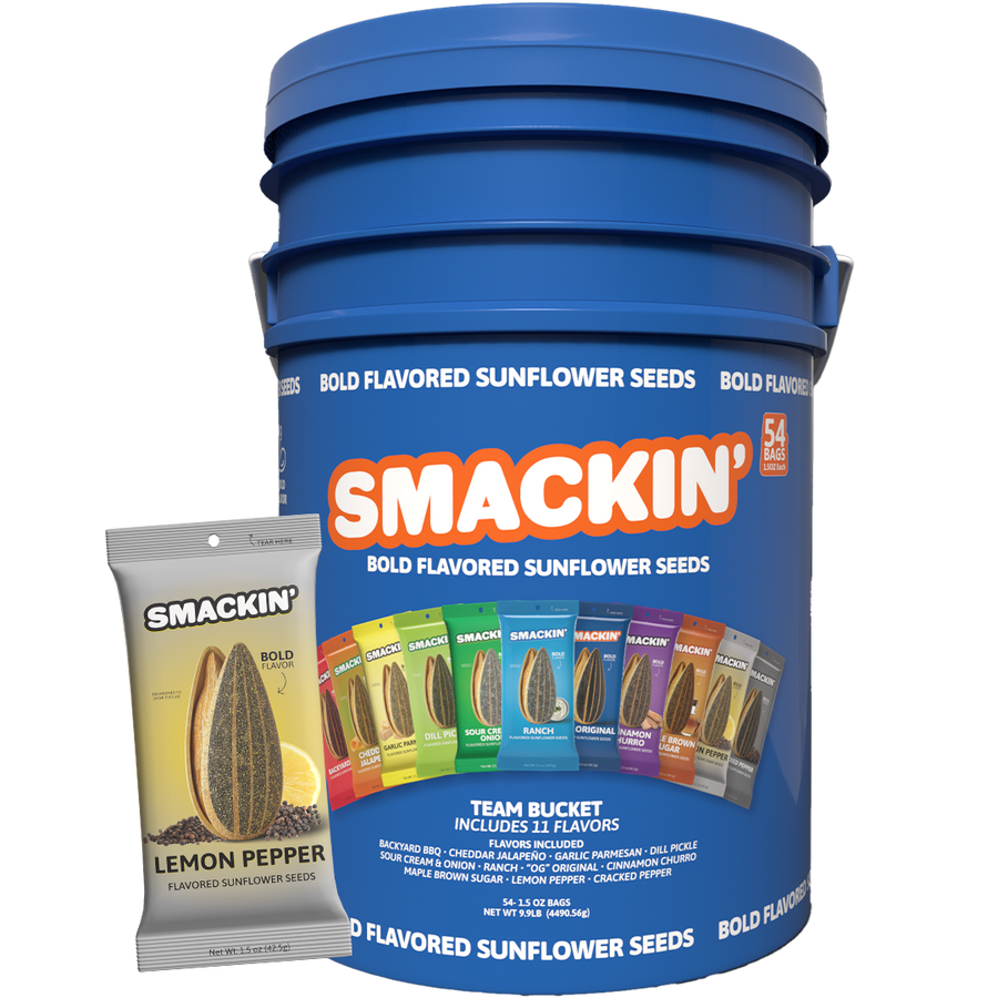 Smackin' Bold Flavored Sunflower Seeds Team Bucket a large blue container with an orange logo holding 54 bags of 11 unique flavors like Lemon Pepper Backyard BBQ and Dill Pickle displayed next to a single yellow Lemon Pepper bag