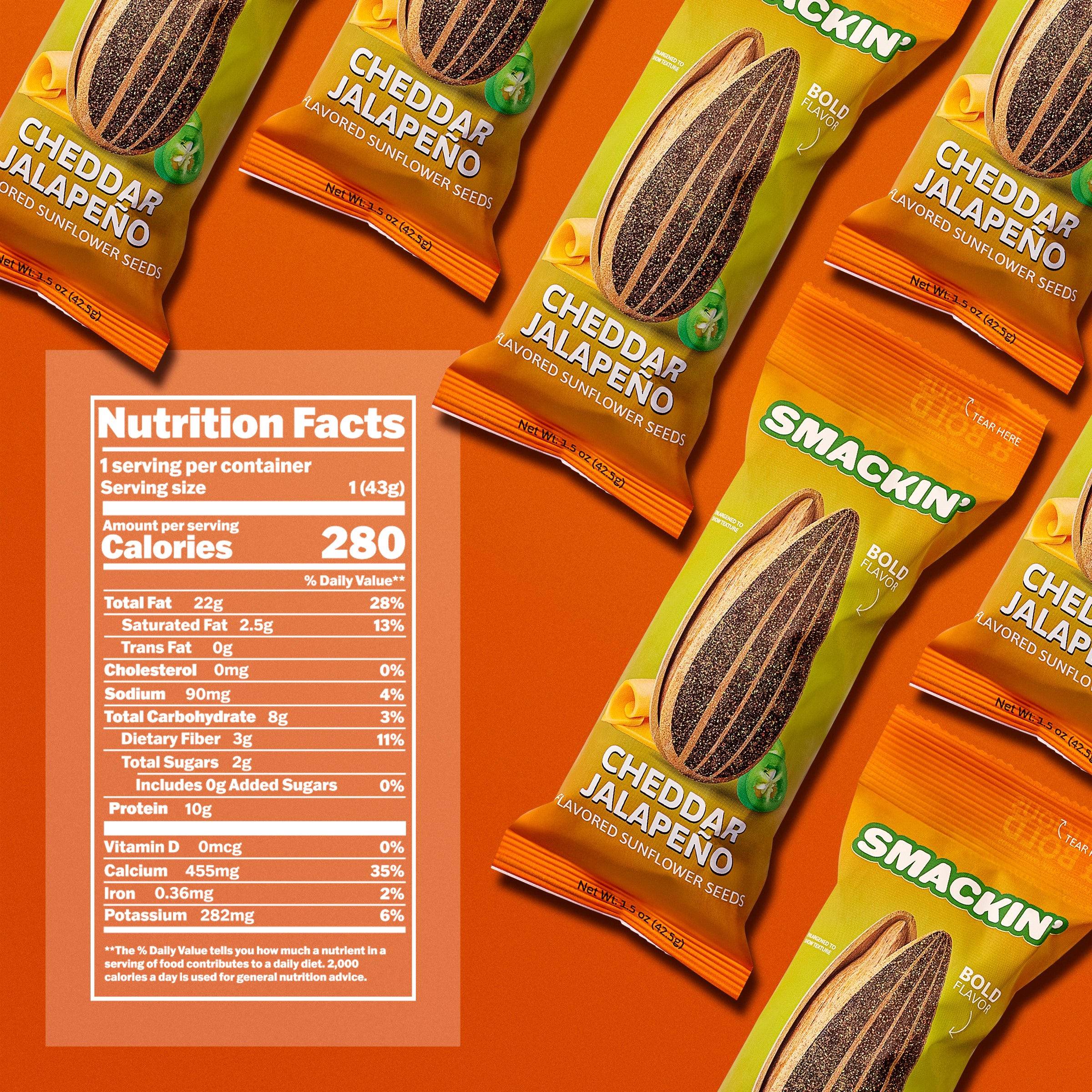 Product photography of multiple SMACKIN' brand Cheddar Jalapeño flavored sunflower seed bags on a vibrant orange background, featuring lime green and orange packaging with a sliced jalapeño graphic and a prominent nutrition facts panel showing 280 calories