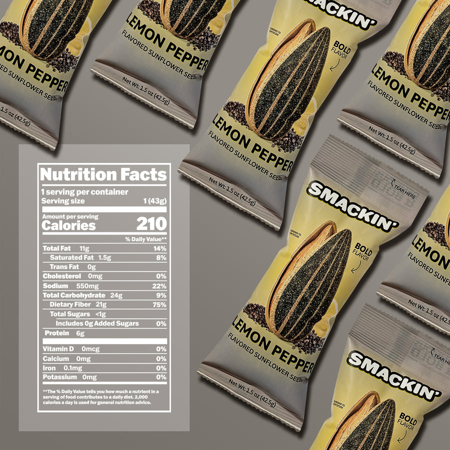 Product photography of multiple Smakin' Lemon Pepper flavored sunflower seed bags on a grey background, featuring vibrant yellow and grey packaging, a prominent sunflower seed and peppercorn design, and a clear nutrition facts label showing 210 calories