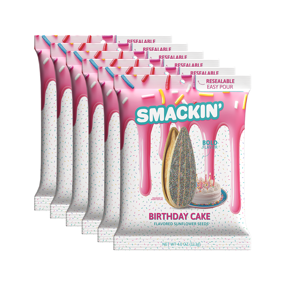 Product packaging, multiple Smackin' Birthday Cake Flavored Sunflower Seeds resealable bags featuring pink dripping icing, a field of colorful sprinkles, a glittery sunflower seed, and a miniature birthday cake with candles