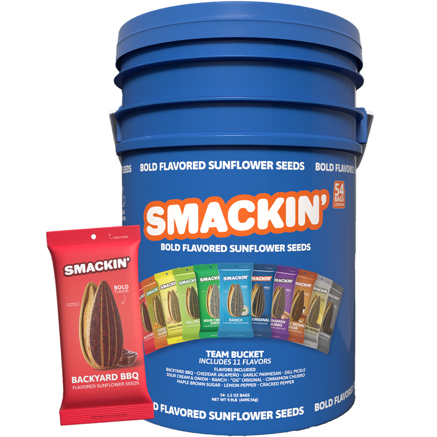 A large blue Smackin' Bold Flavored Sunflower Seeds Team Bucket containing 54 individual bags, prominently displaying a red Backyard BBQ flavored bag and a colorful lineup of 11 diverse flavors like Dill Pickle and Ranch