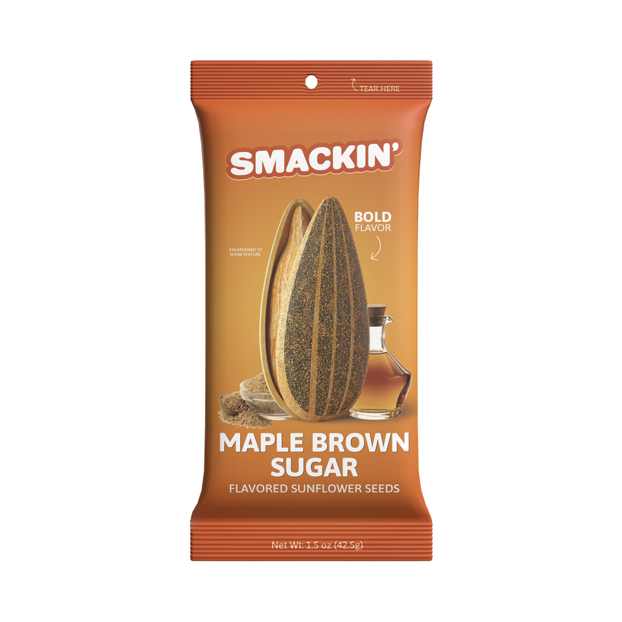 Smackin' brand Maple Brown Sugar flavored sunflower seeds packet in vibrant orange packaging, featuring an enlarged cross-sectioned sunflower seed, a glass bottle of maple syrup, and a small bowl of brown sugar