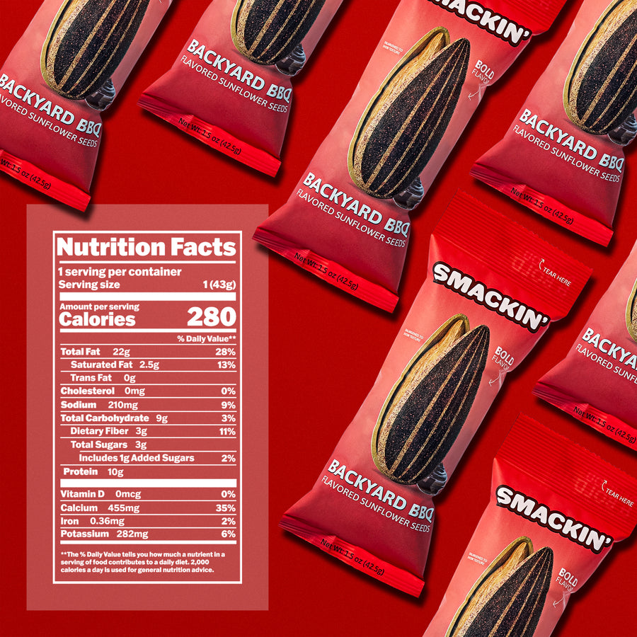 Product photography featuring several red Smackin' Backyard BBQ Flavored Sunflower Seeds pouches with a prominent nutrition facts label showing 280 calories and 10g protein on a vibrant red background