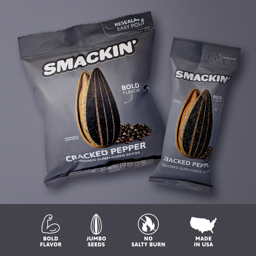 Two gray Smackin' Cracked Pepper flavored sunflower seed bags, displaying an enlarged peppered sunflower seed graphic, "Bold Flavor" branding, a resealable top, and bottom icons indicating Jumbo Seeds and Made in USA