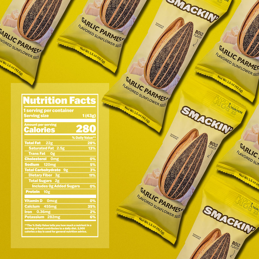 Product photography showing multiple bright yellow Smackin' Garlic Parmesan Flavored Sunflower Seeds packages with a sunflower seed pod graphic, garlic cloves, parmesan cheese, and a visible Nutrition Facts label against a vivid yellow background